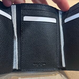 Men’s TriFold Coach Wallet. Brand new! Beautiful black leather.